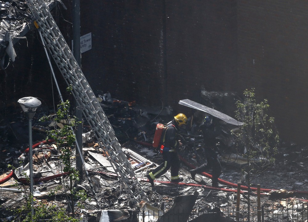 Bombeiros caminham no meio de destroços de prédio em Londres (Foto: REUTERS/Neil Hall)