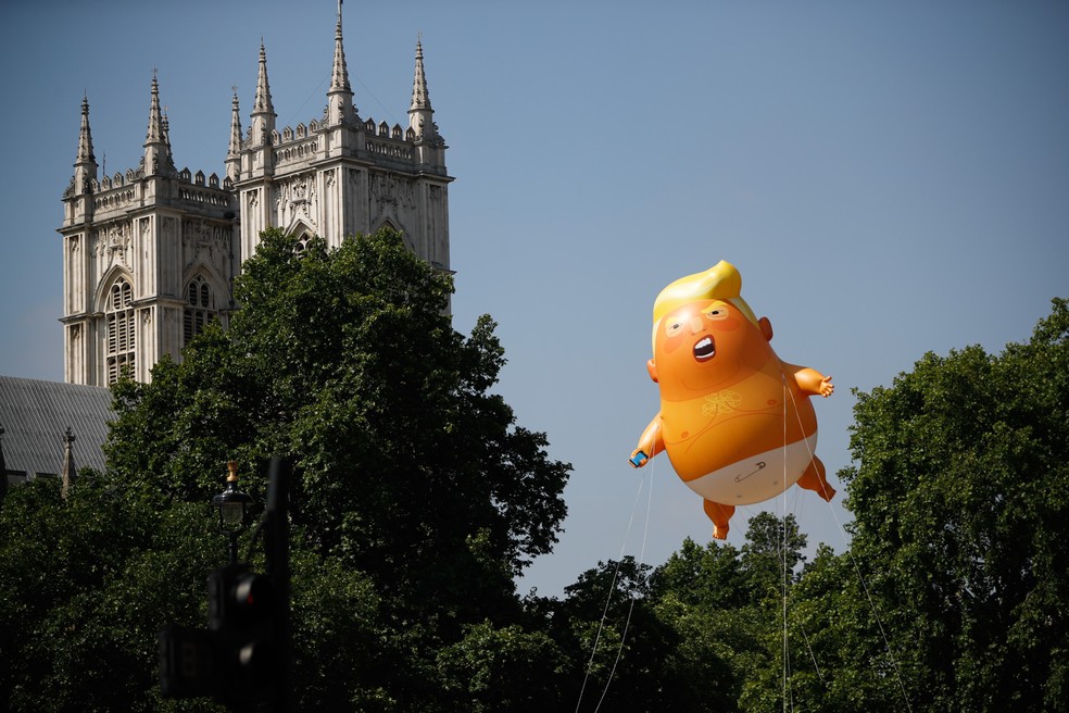 Boneco inflável do presidente dos EUA Donald Trump é visto perto das torres de Westminster Abbey em Londres, na Inglaterra, durante um protesto contra a visita de Trump ao país (Foto: Tolga Akmen/AFP)