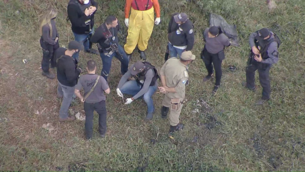 Policiais encontram ossada durante busca por informações que possam levar ao paradeiro de três crianças em Belford Roxo — Foto: Reprodução/ TV Globo