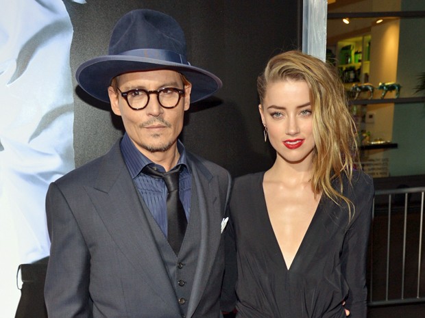 Johnny Depp e a atriz Amber Heard na pré-estreia do filme '3 Days to Kill' em fevereiro deste ano, em Los Angeles (Foto: John Shearer/Invision/AP)
