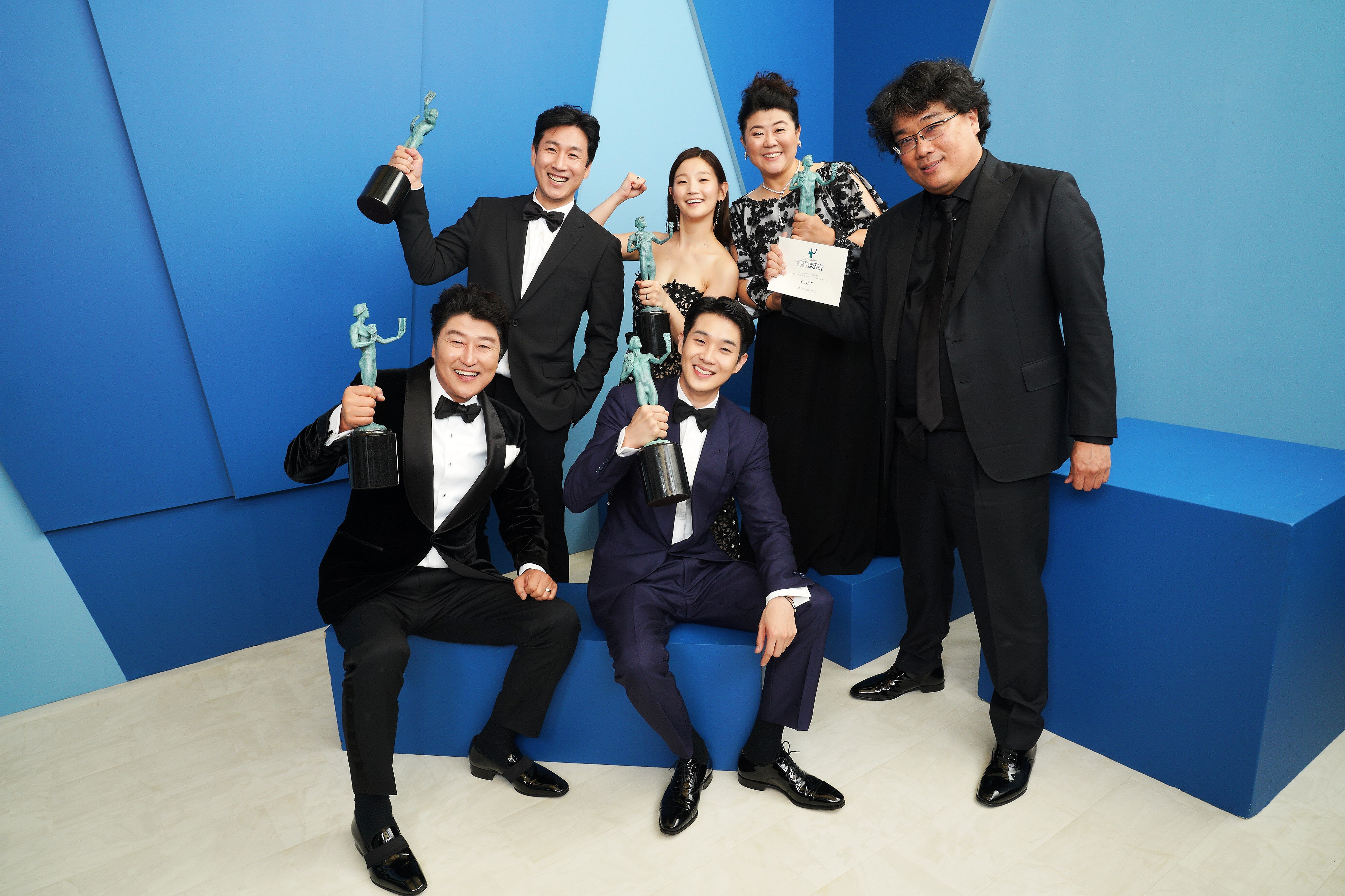 Kang-Ho Song, Lee Sun Gyun, Lee Jung Eun, Choi Woo-shik, Park So-dam e Bong Joon-ho, elenco e diretor de Parasita, comemoram o prêmio principal do AG Award (Foto: Getty)