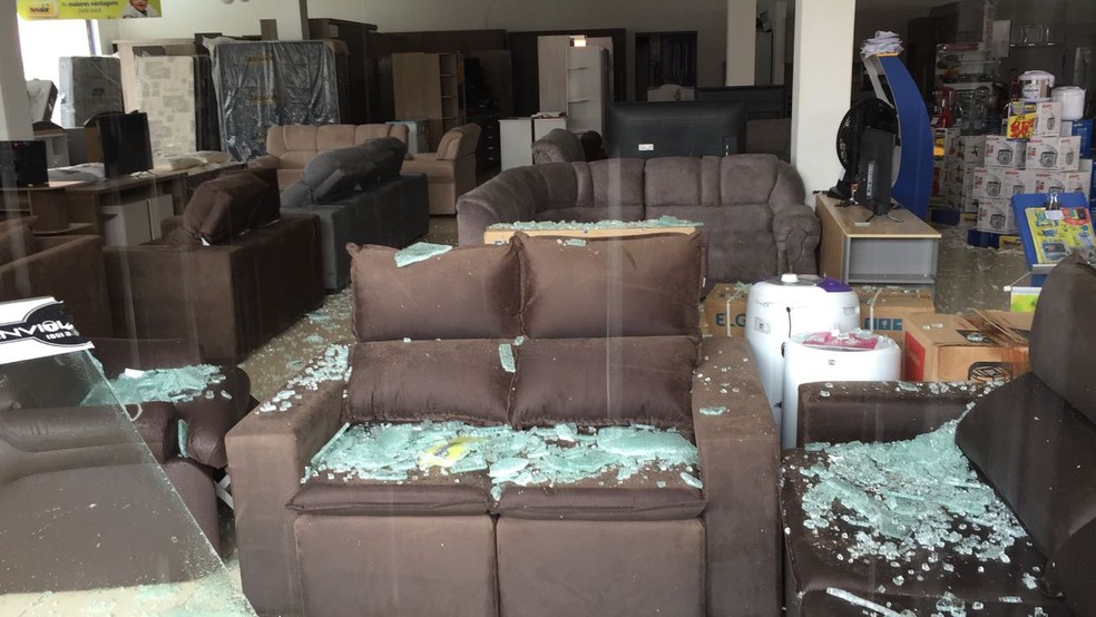 Porta de loja foi quebrada com a força do vento (Foto: WhatsApp/Reprodução)