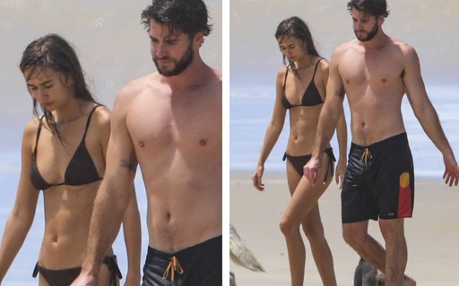Liam Hemsworth e a namorada curtem dia de praia com os cachorros 