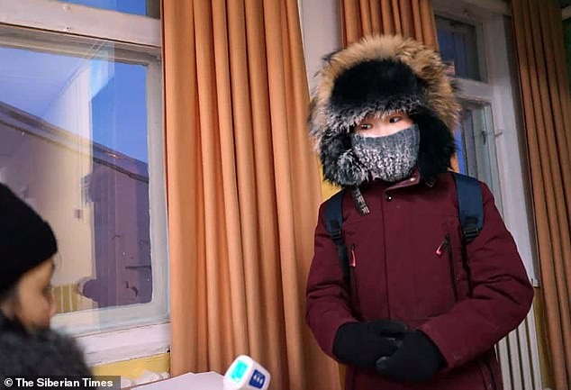 Crianças tem temperatura aferida na porta da escola (Foto: Reprodução/Daily Mail)