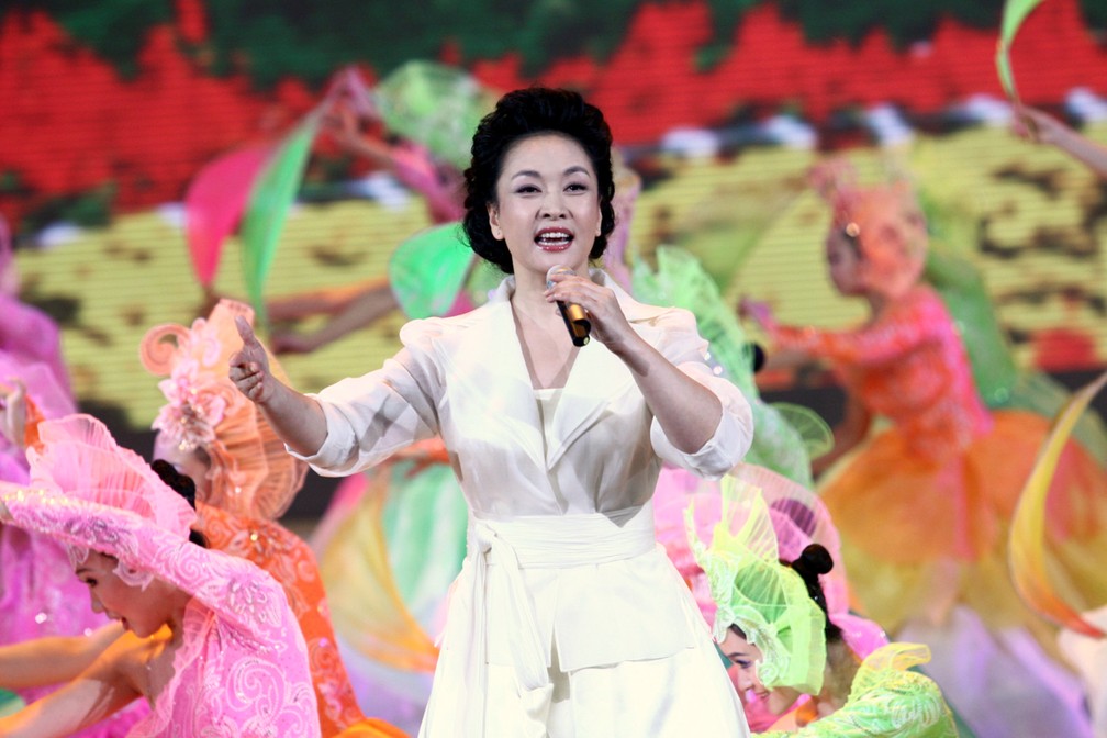 Peng Liyuan, mulher de Xi Jingping, canta durante uma grande celebração em Pequim, em 2009. (Foto: AFP / Imaginechina)