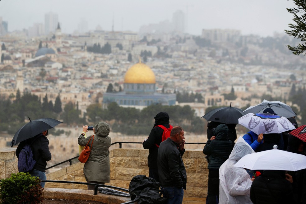 Pessoas observam o Domo da Rocha e a cidade velha de Jerusalém nesta quarta-feira (6)  (Foto: Ammar Awa/ Reuters)