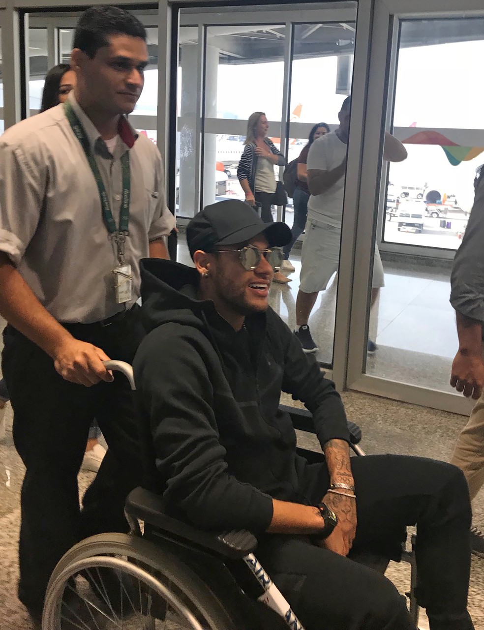 Neymar, de cadeira de rodas, em sua chegada ao Galeão (Foto: Claire Dornald Clauzel / Twitter / AFP)