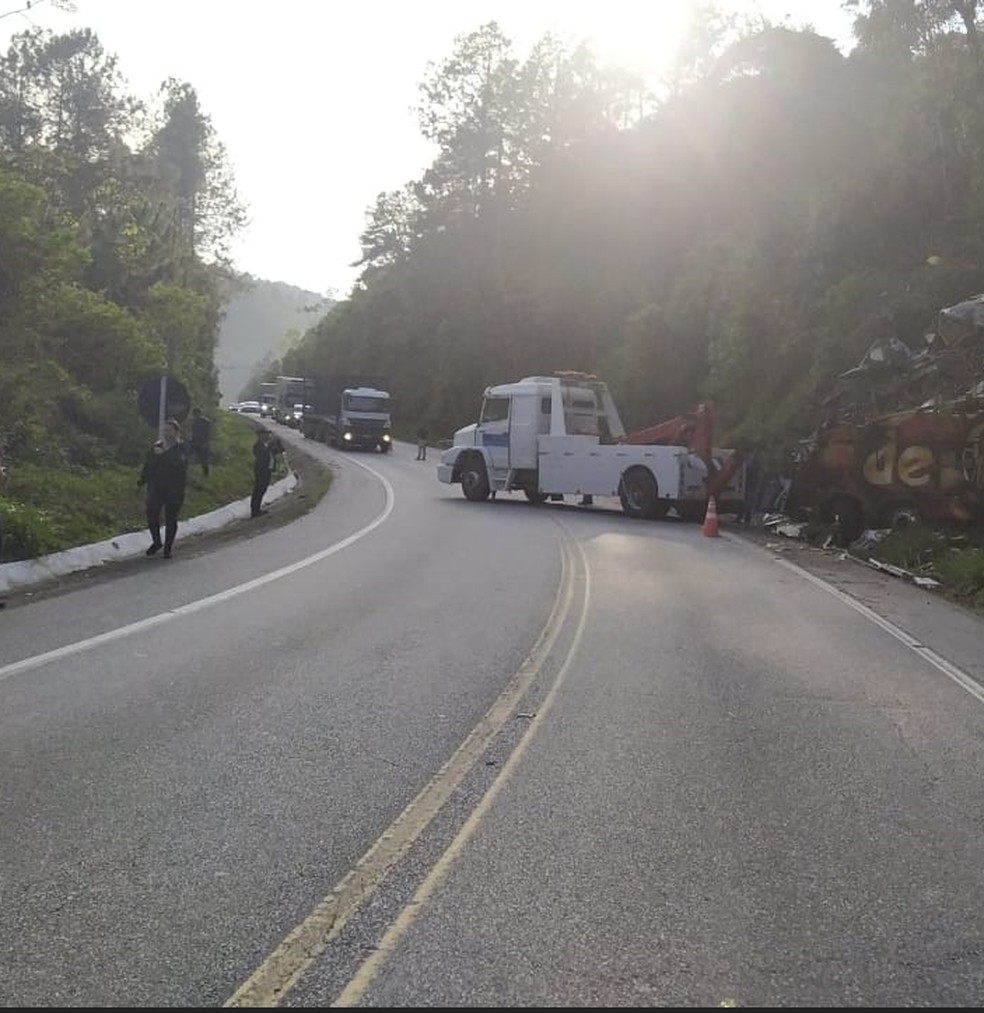 Ônibus da banda sendo retirado da pista nesta segunda-feira (13) — Foto: Polícia Rodoviária Federal/Divulgação