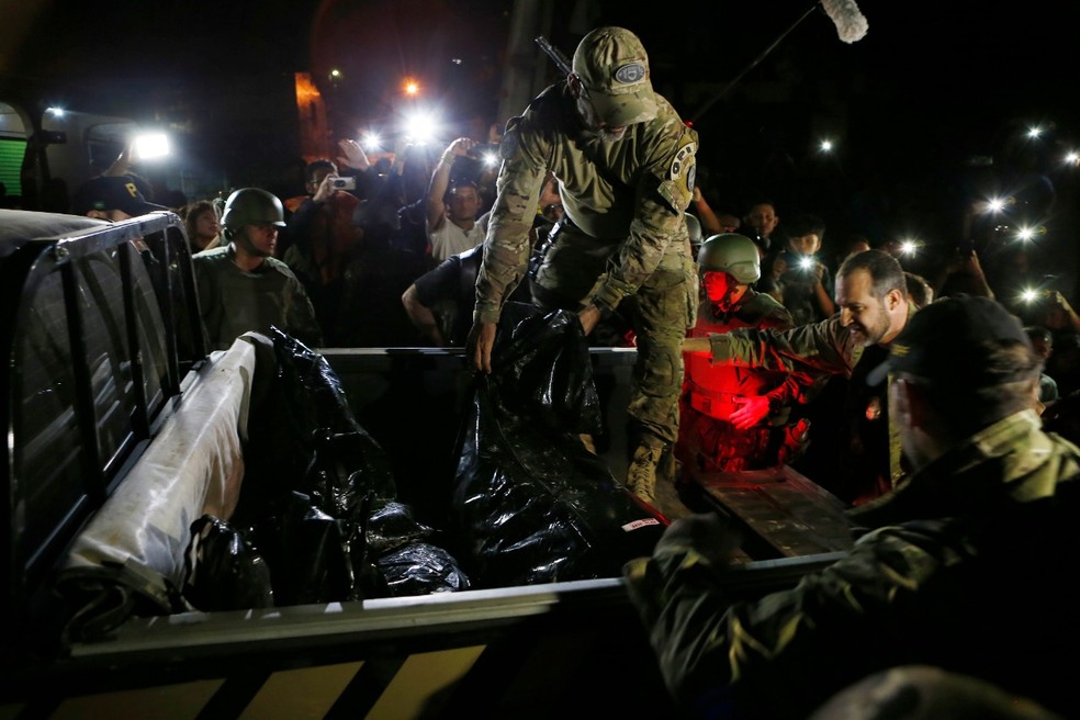 'Remanescentes humanos' foram transportados no início da noite. — Foto: Edmar Barros/AP