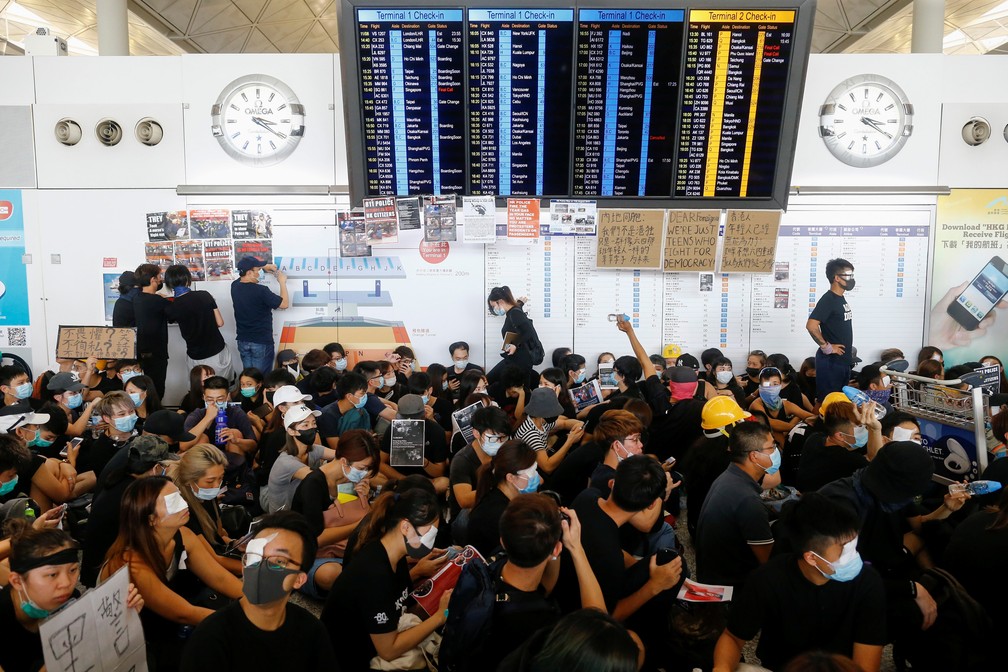 Manifestantes ocuparam o aeroporto de Hong Kong nesta segunda-feira (12), causando o cancelamento dos voos. — Foto: Thomas Peter/Reuters