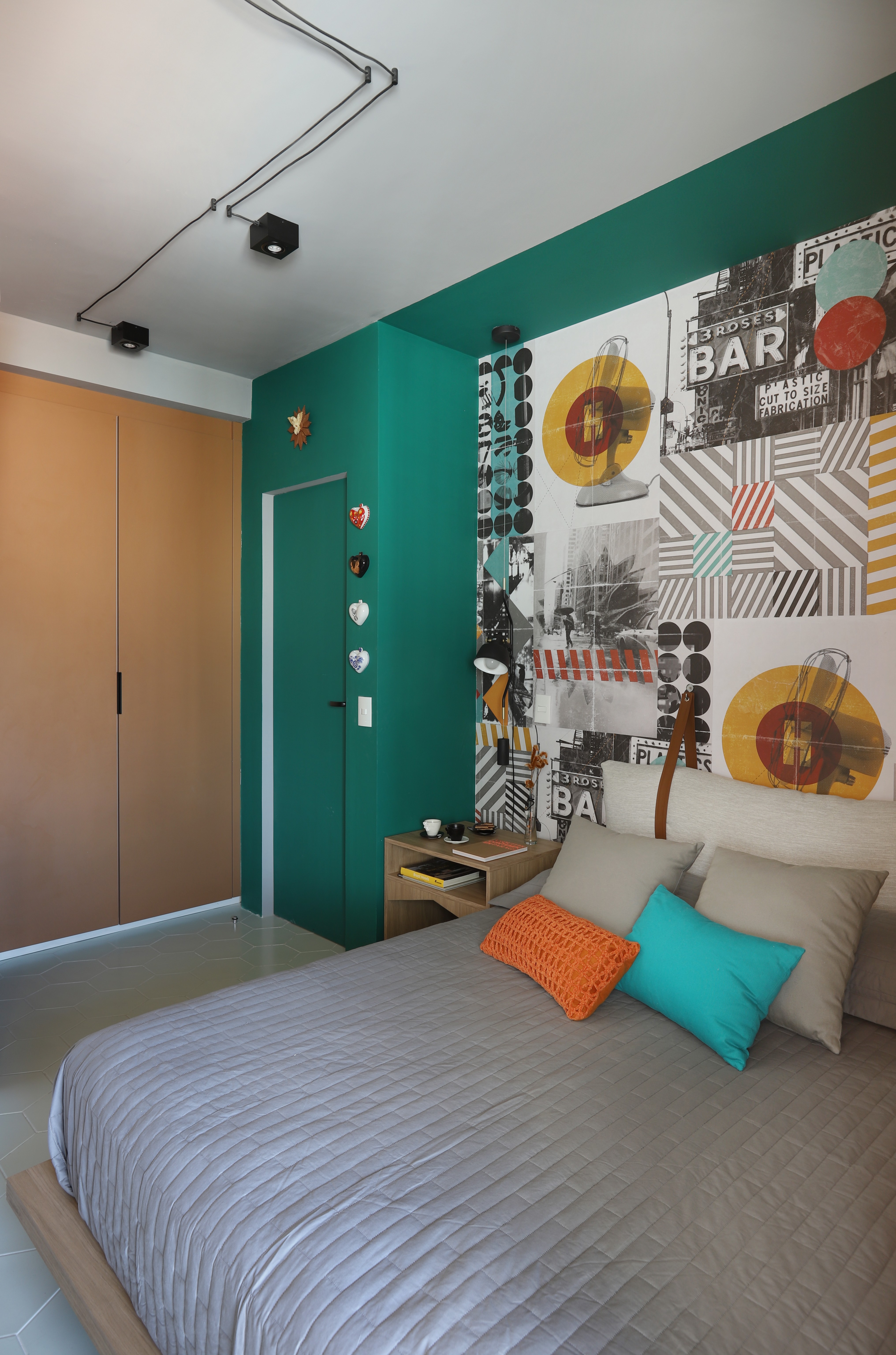QUARTO | O painel atrás da cama traz mais cores, que se misturam com o verde da parede  (Foto: Divulgação / Mariana Orsi)