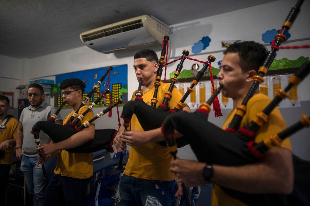 Jovens de escola de São Gonçalo fazem apresentações com gaitas de fole — Foto: MAURO PIMENTEL/AFP