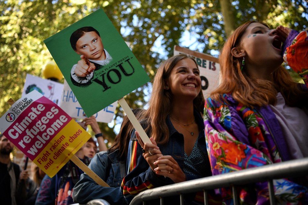 Manifestante segura cartaz com foto de Greta Thunberg durante protesto em Londres nesta sexta (20). — Foto: Ben Stansall / AFP