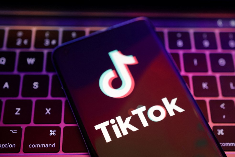 Celular sobre teclado de notebook com a logo do aplicativo TikTok — Foto: Dado Ruvic/Illustration/REUTERS