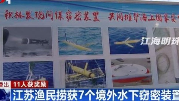 Tela de televisão mostra reportagem sobre drones encontrados pelo mar na China  (Foto: Reprodução/BBC )
