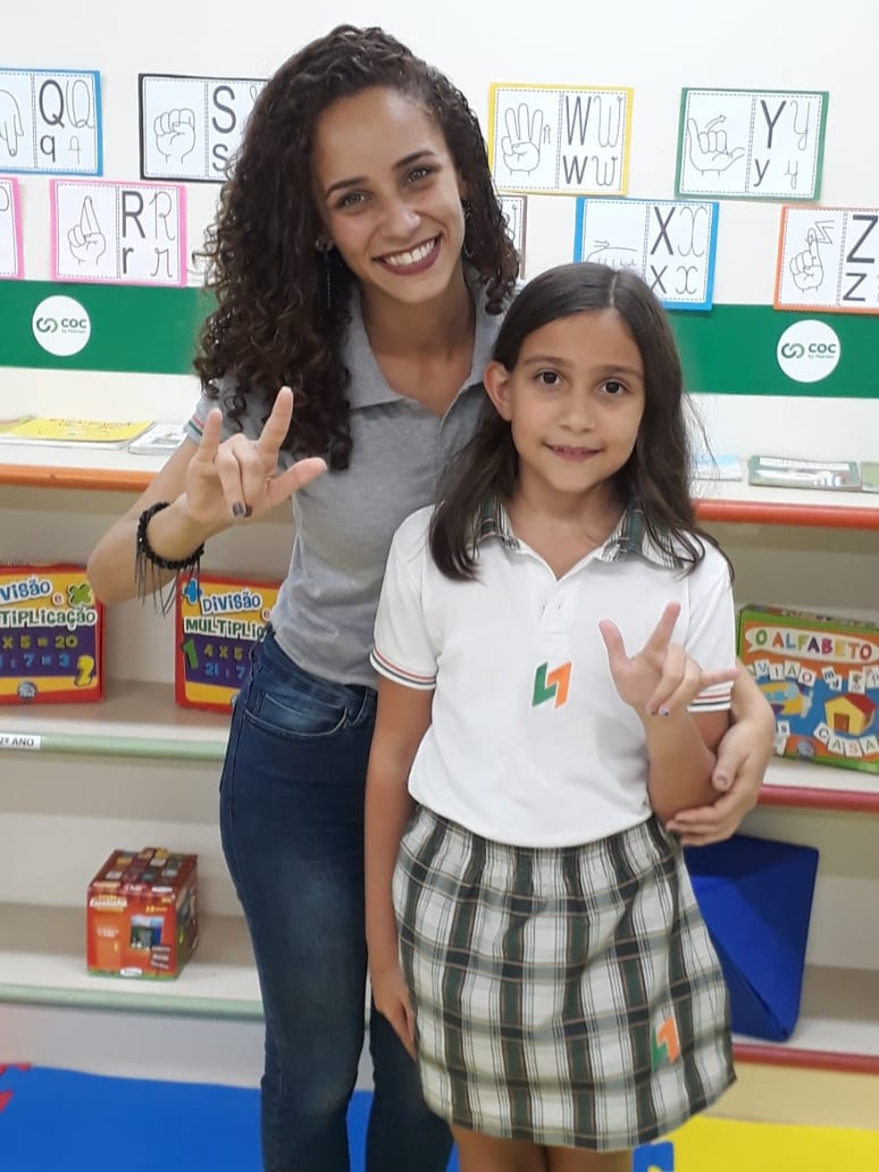 Professora e aluna fazem sinal que representa "eu te amo" em libras â Foto: DivulgaÃ§Ã£o 