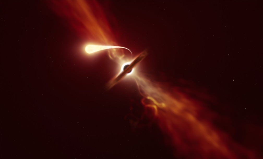 Impressão artística mostra estrela (em primeiro plano) sendo espaguetificada enquanto é engolida por um buraco negro supermassivo (ao fundo) durante um 'evento de interrupção de maré'. — Foto: ESO/M. Kornmesser