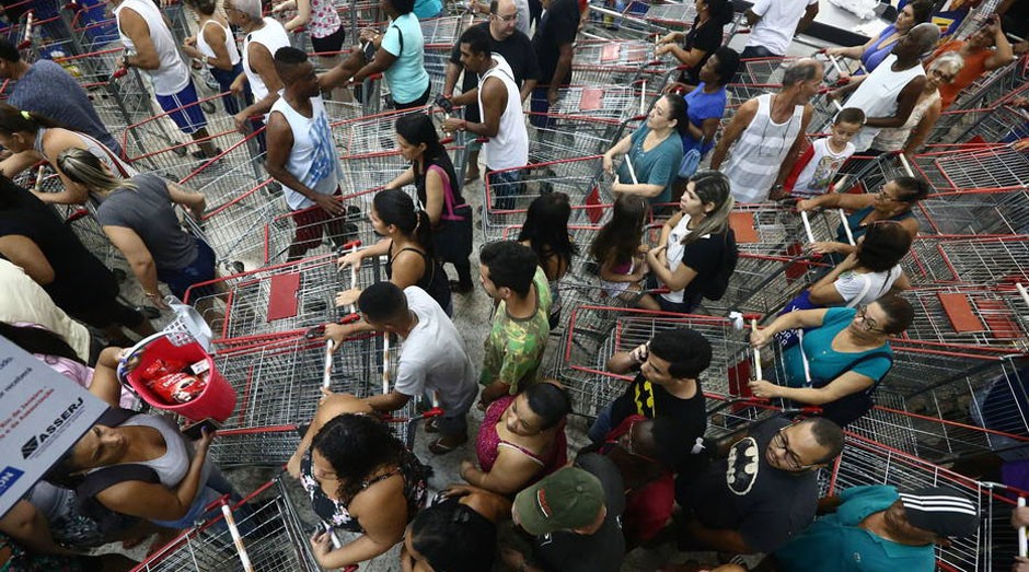 Consumidores fizeram fila nas portas dos supermercados da rede Guanabara desde a madrugada (Foto: Reprodução/Estadão Conteúdo)
