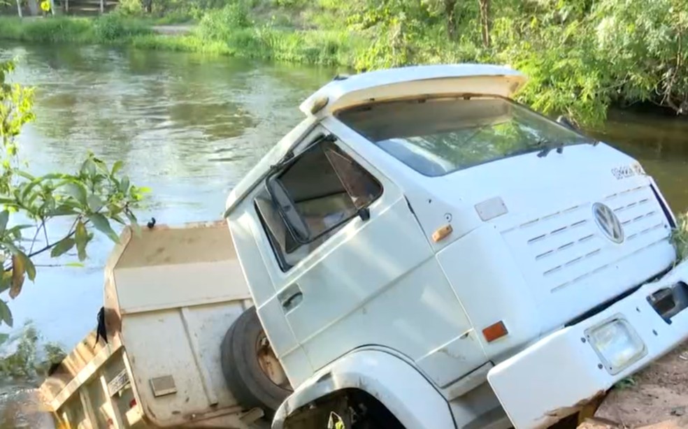 Veículo ficou pendurado pelo para-choque com a caçamba dentro do rio, em Barreiras — Foto: Reprodução/TV Oeste