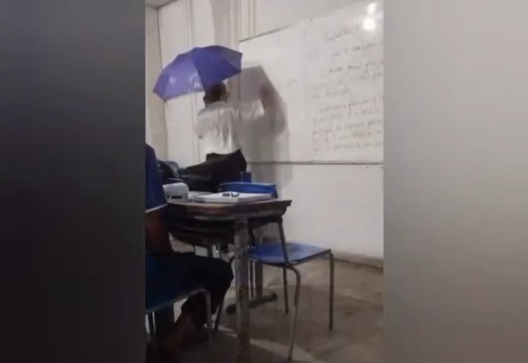 Professora usa guarda-chuva em sala de aula para se proteger da chuva no Pará