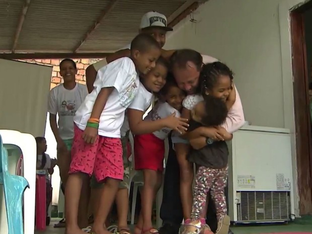 Sérgio abraça crianças que ajuda na Bahia (Foto: Reprodução/TV Bahia)