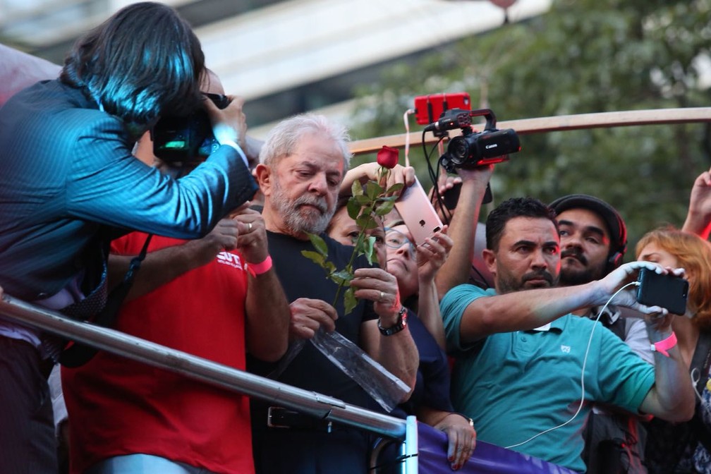 Lula recebe rosa de militante durante ato na Praça da República (Foto: Celso Tavares/G1)