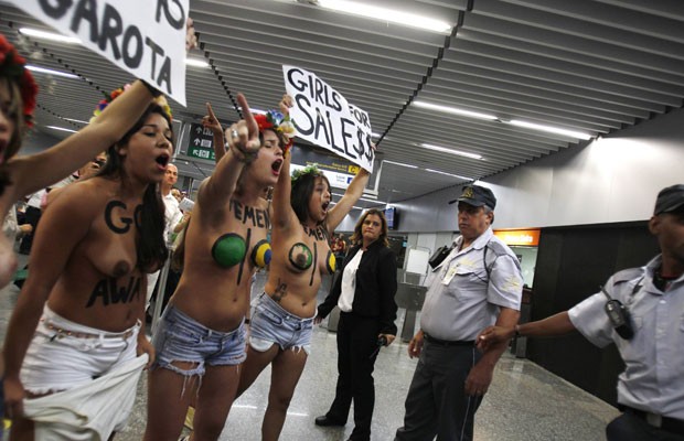 Integrantes do movimento feminista Femen protestam na manhã desta sexta-feira (8) no Aeroporto Internacional do Rio de Janeiro (Foto: Pilar Olivares/Reuters)
