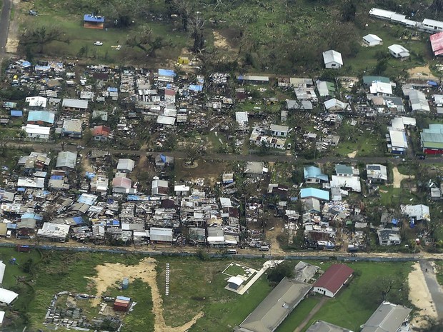 Imagem aérea mostra residência destruídas pelos ventos do tufão Pam em Vanuatu, que chegaram a 320 km/h. O presidente de Vanuatu, Baldwin Lonsdale, declarou que a mudança climática foi um fator-chave na devastação sofrida pelo paí (Foto: Dave Hunt/AFP/Pool)