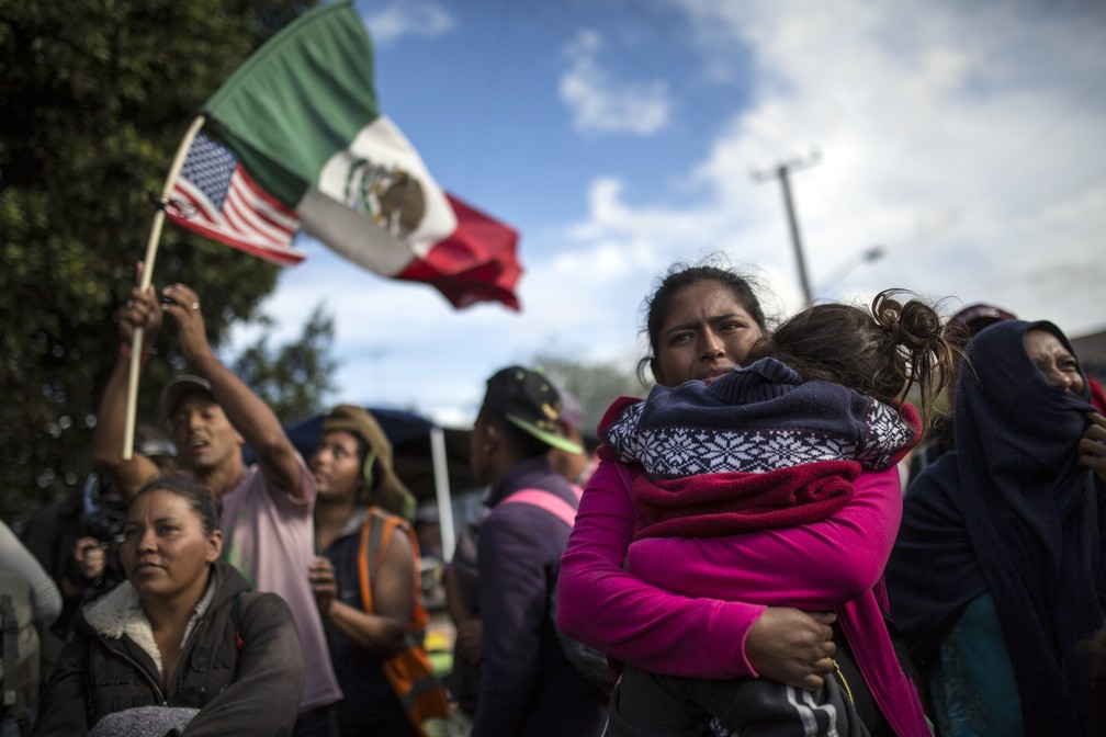 FamÃ­lia de migrantes centro-americanos protestam nesta quinta-feira (22) em El Chaparral, na fronteira com os EUA, onde pretendem entrar para pedir refÃºgio â Foto: Rodrigo Abd/AP Photo