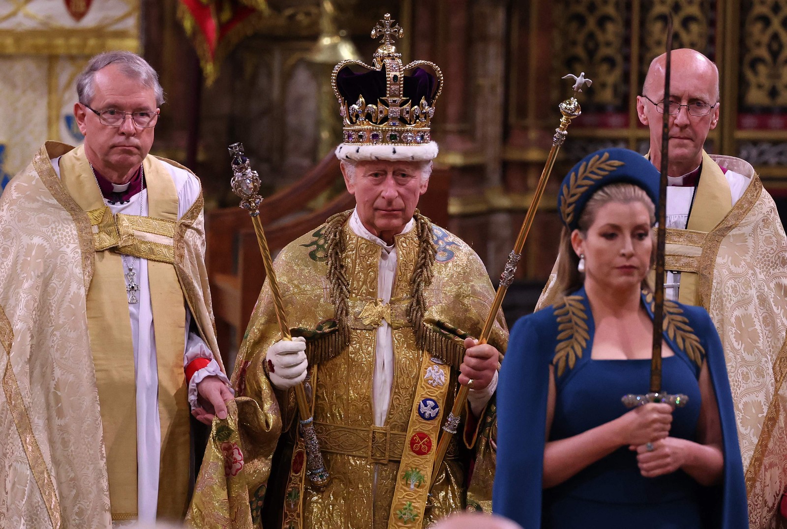 O rei Charles caminha vestindo a Coroa de Santo Eduardo durante a cerimônia de coroação na Abadia de Westminster — Foto: Richard POHLE / POOL / AFP