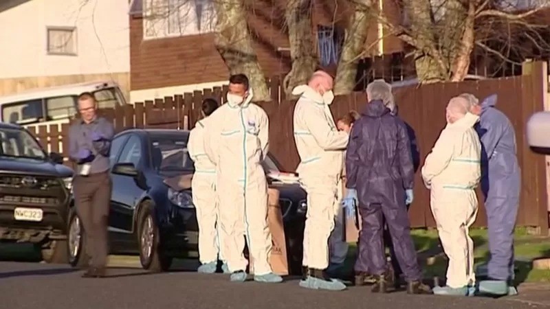 Investigadores forenses do lado de fora de uma casa localizada nos subúrbios de Auckland, onde os corpos foram encontrados no mês passado (Foto: TVNZ/REUTERS via BBC)