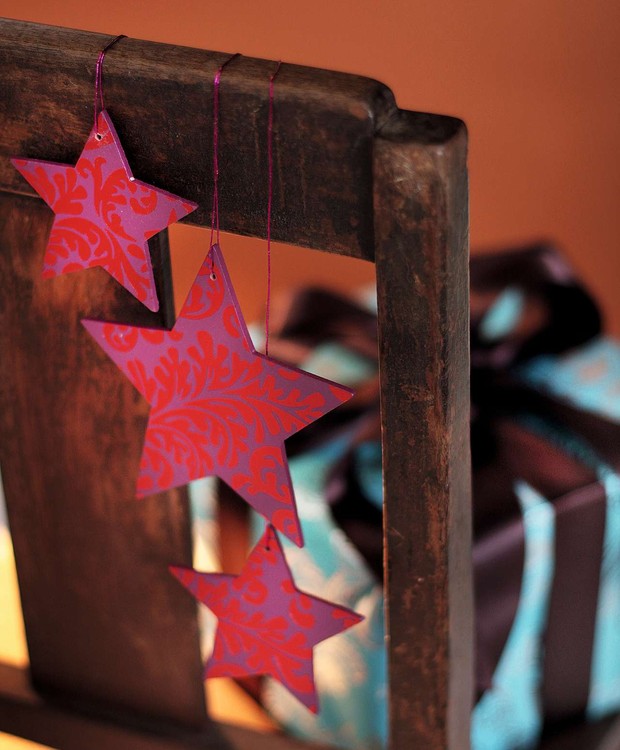 Pendurar estrelas coloridas no encosto das cadeiras ajuda a casa toda a entrar no clima de celebração de fim de ano (Foto: Rogério Voltan/Casa e Comida)