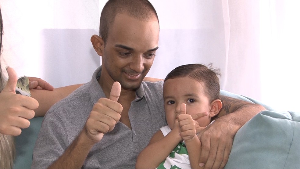 Victor Cout com o filho durante entrevista ao G1 (Foto: Miguel Folco/ G1)