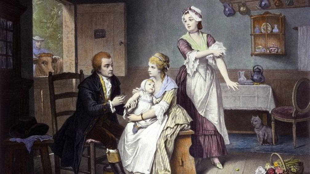 Edward Jenner, inventor da vacina, aplica imuniza&ccedil;&atilde;o no pr&oacute;prio filho, nos bra&ccedil;os da m&atilde;e, em obra de E. Hamman e C. Manigaud &mdash; Foto: Wellcome Collection/BBC