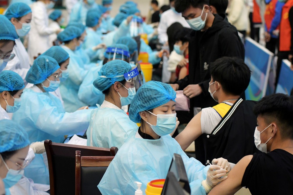 Profissionais de saúde aplicam vacinas em estudantes em Qingdao, na China — Foto: Reuters