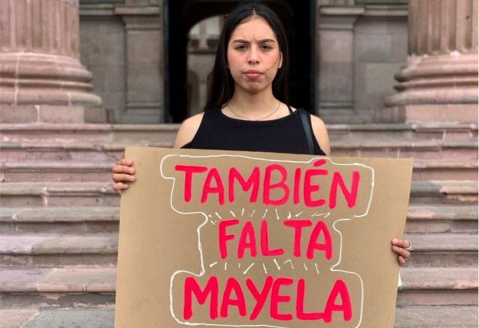 Maya Hern&aacute;ndez segura uma placa dizendo que sua m&atilde;e tamb&eacute;m est&aacute; desaparecida &mdash; Foto: MARCOS GONZ&Aacute;LEZ / BBC