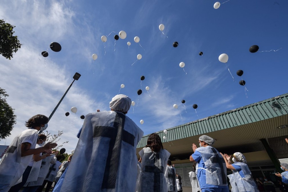 12 de maio: profissionais de saúde fazem homenagem a colegas que perderam a vida tratando pacientes de Covid-19 em frente ao Hospital das Clínicas da USP, em São Paulo. — Foto: Nelson Almeida/AFP