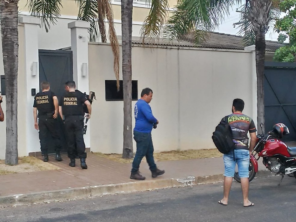 Agentes da PF entrando na casa do ex-governador Marcelo Miranda, em Palmas — Foto: Ana Paula Rehbein/TV Anhanguera