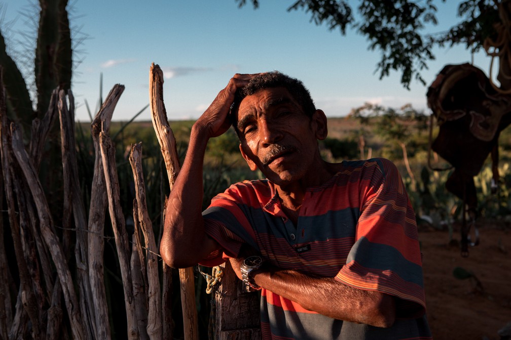 O agricultor Roberto Raimundo de Sá, de 62 anos, é visto durante o entardecer na entrada de sua casa na região de Jeremoabo, na Bahia — Foto: Marcelo Brandt/G1