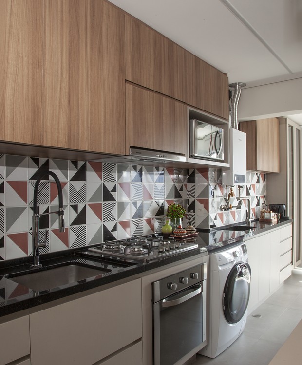Neste projeto do Studio Tan-Gram, a área de serviço é aberta e uma extensão da cozinha, que ganhou azulejos coloridos (Foto: Luís Gomes de Souza / Divulgação)