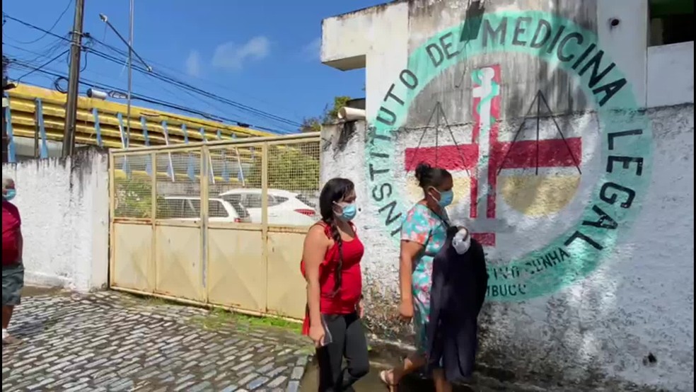 Parecentes de homem que morreu aos ser atacado por tubarão liberaram corpo, neste domingo (11), no IML — Foto: Júlia Montenegro/TV Globo 