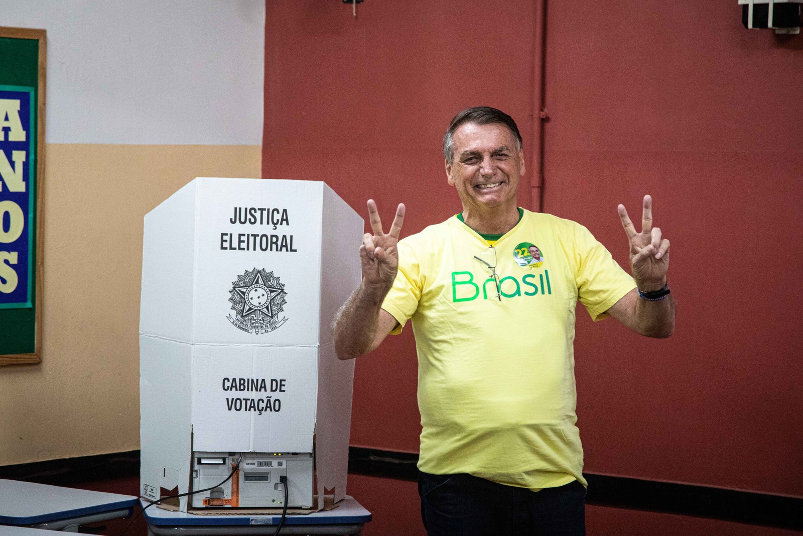 O presidente Jair Bolsonaro faz o 'v' de vitória ao votar na Vila Militar. — Foto: Hermes de Paula