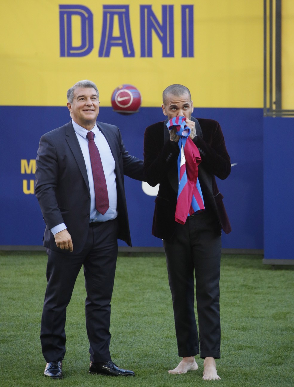 Daniel Alves, descalço e a ao lado de Laporta, no gramado do Camp Nou durante apresentação — Foto: REUTERS