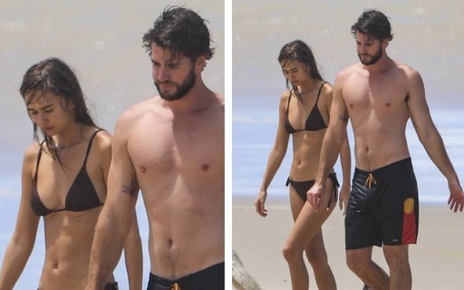 Liam Hemsworth e a namorada curtem dia de praia com os cachorros 