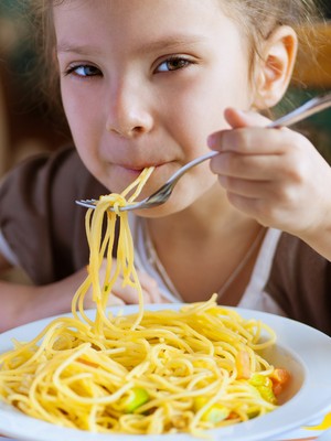 Criança comendo macarrão (Foto: Shutterstock)