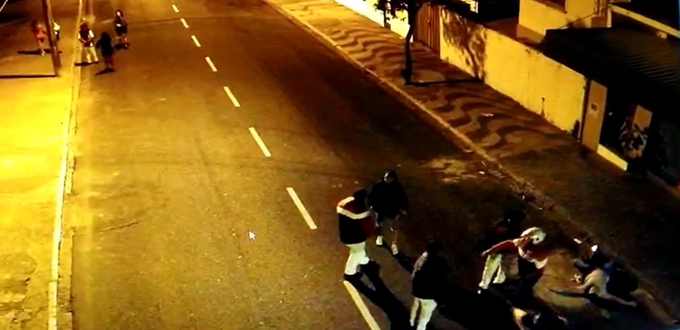 Imagens da câmera de segurança mostram jovem caído ao lado da guia da calçada após ser agredido em Garça (SP) — Foto: Circuito de Segurança/ Reprodução