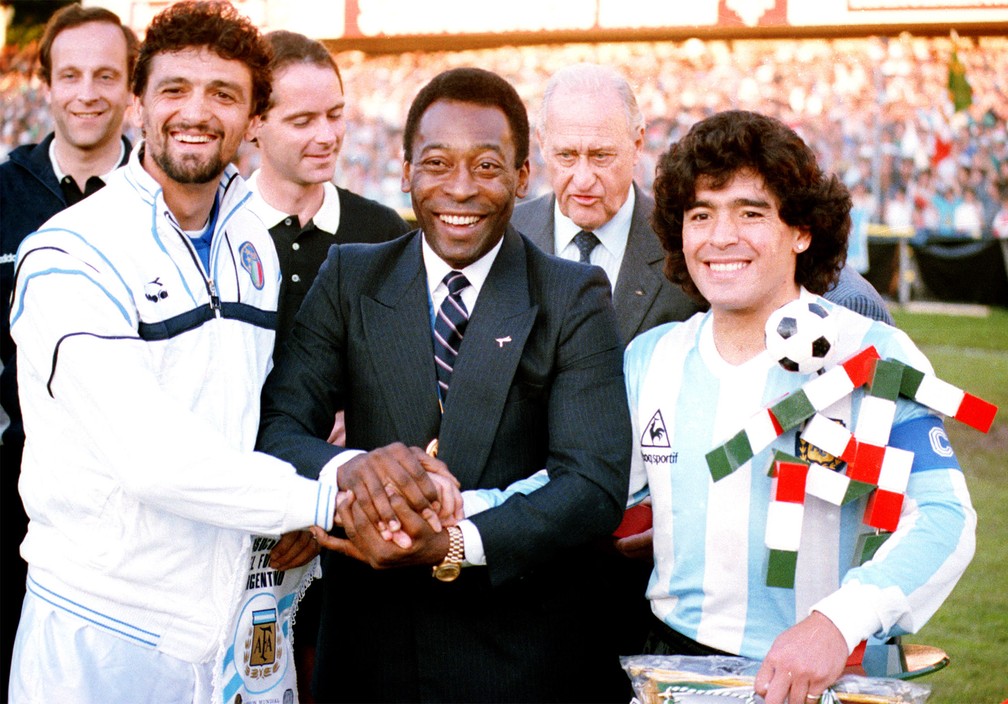Pelé une as mãos de Maradona e do capitão da seleção da Itália, Alessandro Altobelli, antes de partida entre Argentina e Itália em junho de 1987 — Foto: AP/Arquivo