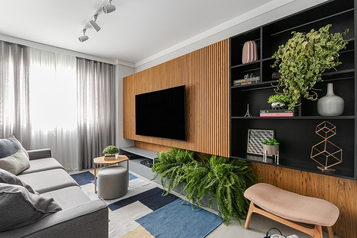 SALA DE TV | O sofá, as mesas de centro e laterais e o pufe são da Líder Interiores. O tapete é da Koord e as almofadas, da Indore Design (Foto: Gisele Rampazzo / Divulgação)