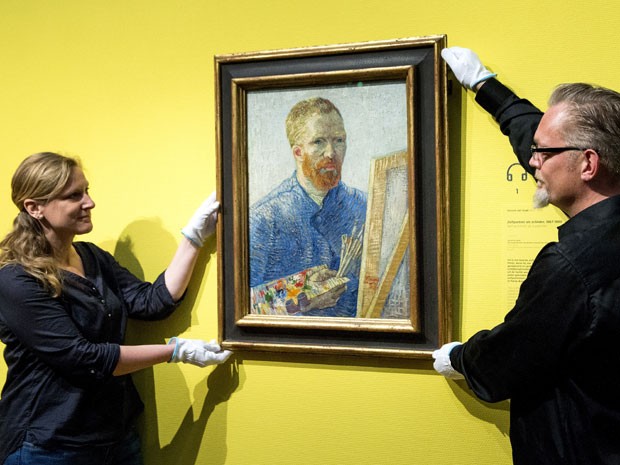 Funcionários do museu Van Gogh mostram autorretrato do pintor holandês, datado de 1888, pouco antes da reabertura da instituição, nesta quarta-feira (1º de maio de 2014) (Foto: Koen Van Wee/AFP)