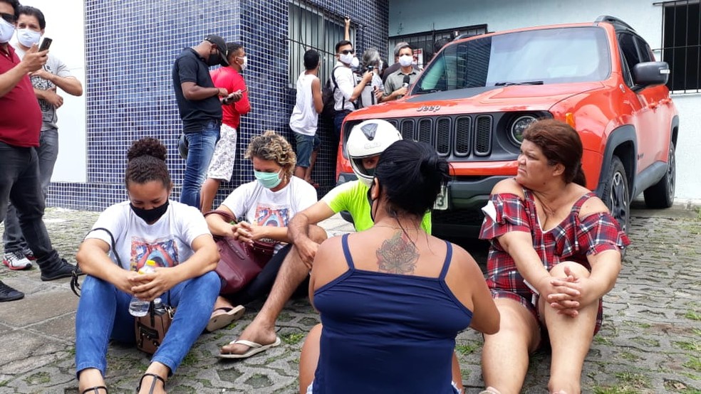 Parentes do menino Miguel sentaram em frente ao carro em que Sari Corte Real chegou, no Recife, nesta segunda-feira (29) — Foto: Marina Meireles/G1